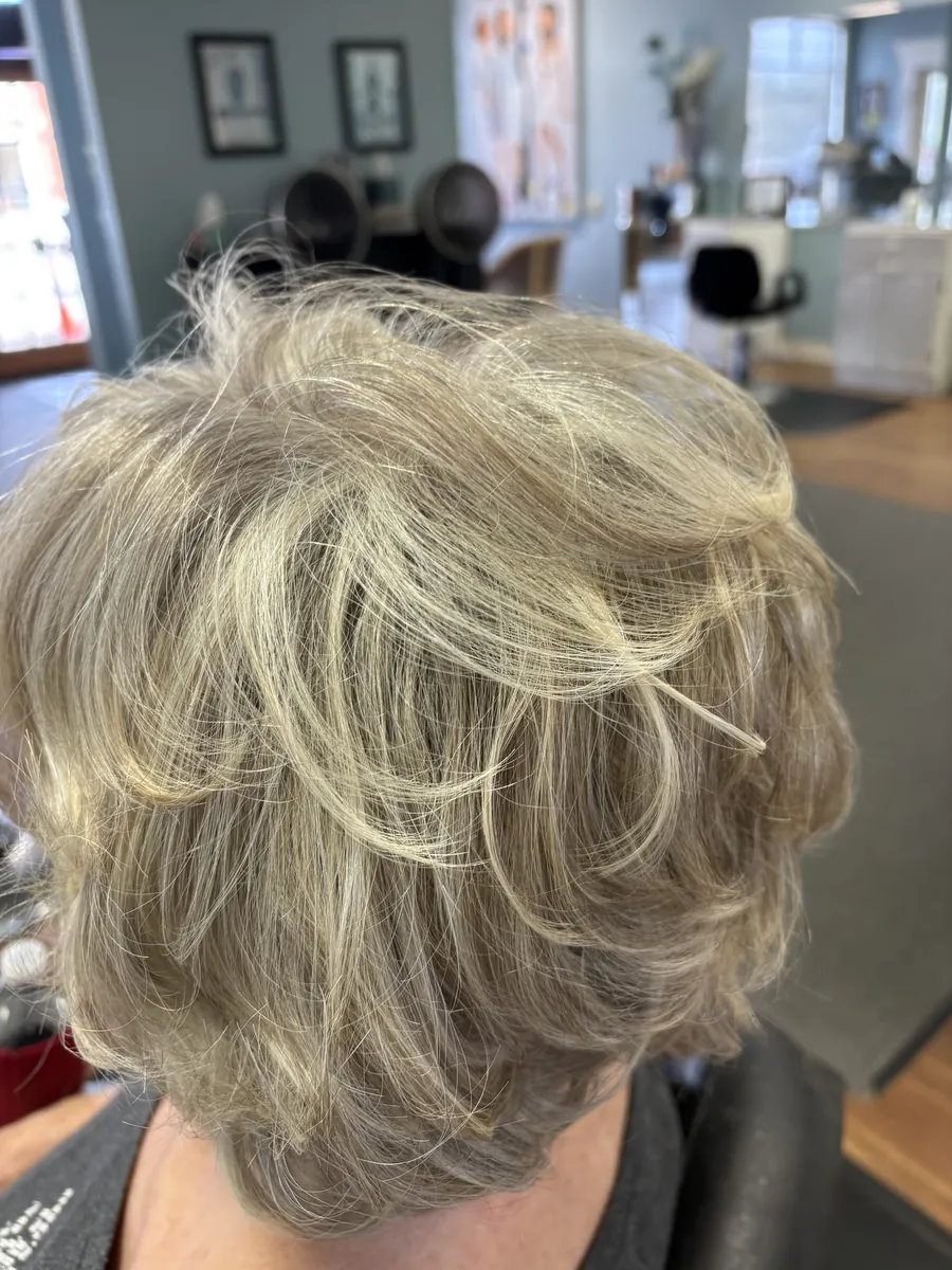 Soft layered blonde haircut, back view